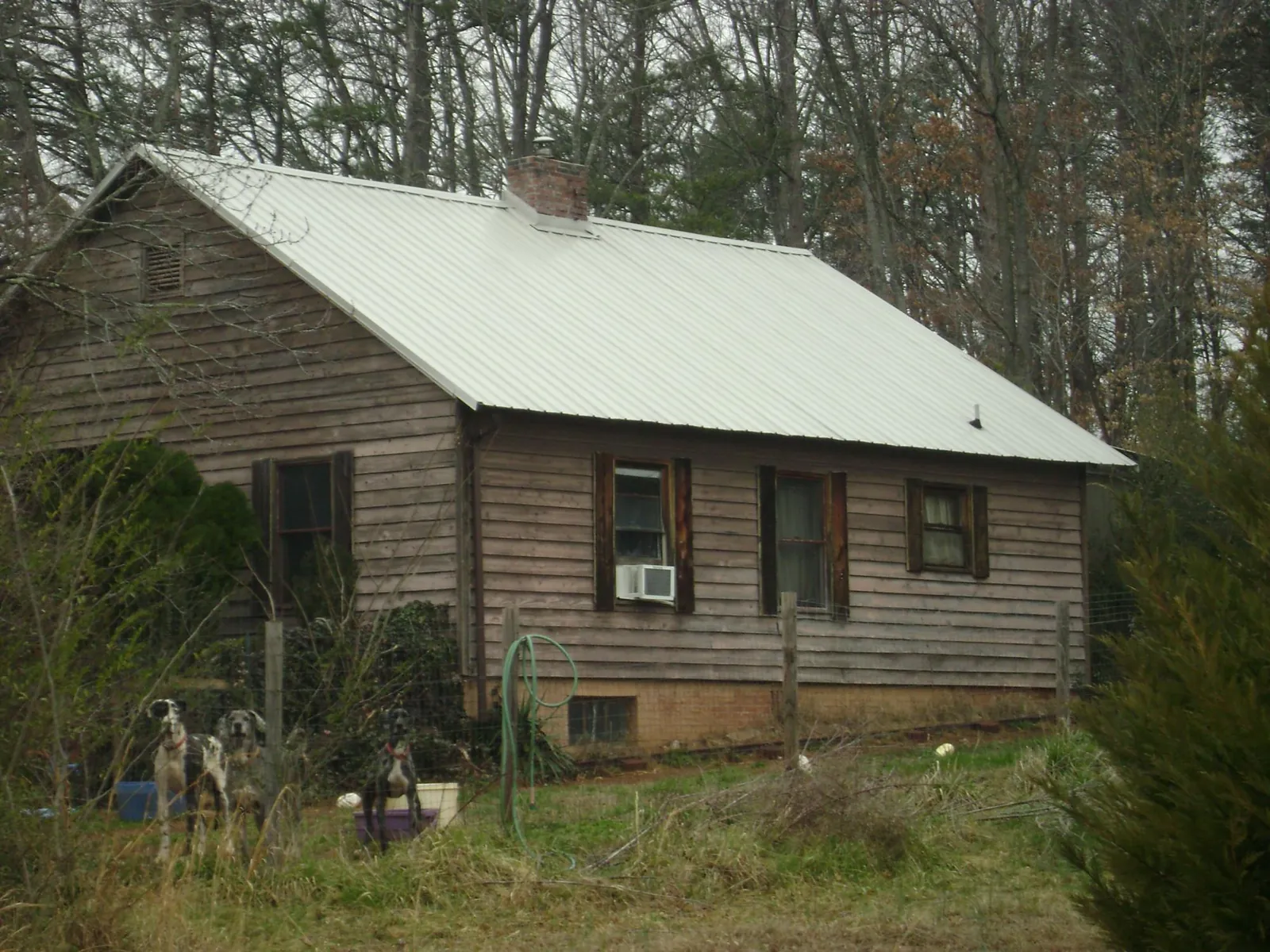 White metal roof on an old wood sided farmhouse, from a Metal Roof Installation job in Edinboro